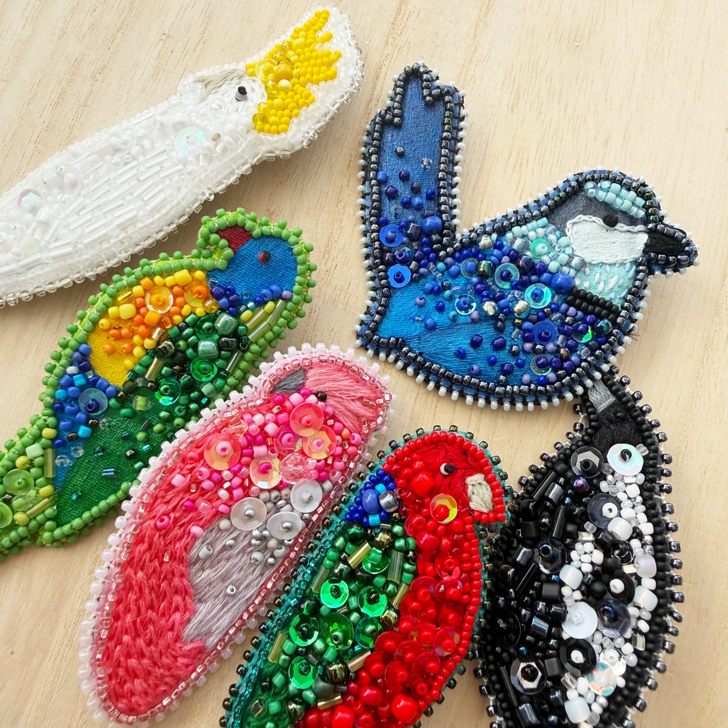 colourful group of hand beaded Australian bird brooches
