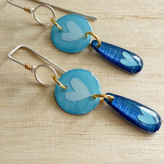 blue heart drop earrings on a wooden surface